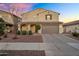 Charming two-story home featuring a well-manicured lawn, a tile roof and a two car garage at 13553 N 141St Ln, Surprise, AZ 85379