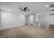 Bright and airy loft space with carpet flooring and a modern ceiling fan at 13553 N 141St Ln, Surprise, AZ 85379