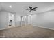 Open loft area with neutral walls, carpet flooring, and multiple doorways at 13553 N 141St Ln, Surprise, AZ 85379