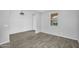 A light filled room with wood-look tile flooring, light gray walls, and a shiplap accent wall at 13553 N 141St Ln, Surprise, AZ 85379