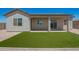 Home featuring a cozy backyard with artificial turf at 14861 S Capistrano Rd, Arizona City, AZ 85123