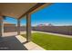 Covered patio overlooks a well-maintained backyard with artificial turf and a block wall for privacy at 14861 S Capistrano Rd, Arizona City, AZ 85123