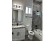 Updated bathroom featuring gray tile, granite counters, white cabinets with dark pulls, and gray wood-look tile floors at 14861 S Capistrano Rd, Arizona City, AZ 85123