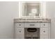 Bathroom vanity with granite countertop, drawers, cabinets and lighted mirror at 14861 S Capistrano Rd, Arizona City, AZ 85123