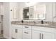 Bathroom featuring double sink vanity, granite countertop, and large lighted mirror at 14861 S Capistrano Rd, Arizona City, AZ 85123