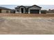 Single-story home with neutral-colored stucco, an attached two-car garage, and desert landscaping at 14861 S Capistrano Rd, Arizona City, AZ 85123