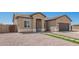 View of a new construction beige home with desert landscaping, artificial turf walkway, and a two-car garage at 14861 S Capistrano Rd, Arizona City, AZ 85123