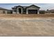 Single-story home with neutral-colored stucco, an attached two-car garage, and desert landscaping at 14861 S Capistrano Rd, Arizona City, AZ 85123
