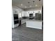 Spacious kitchen features recessed lighting, granite countertops, an island, white cabinets, and stainless steel appliances at 14861 S Capistrano Rd, Arizona City, AZ 85123