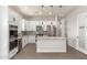Modern kitchen featuring stainless steel appliances, white cabinets, granite countertops, and a center island at 14861 S Capistrano Rd, Arizona City, AZ 85123