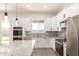 Open kitchen with modern appliances, granite counters, a center island, and ample cabinet space at 14861 S Capistrano Rd, Arizona City, AZ 85123