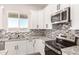 Close-up of kitchen featuring granite countertops, stainless steel appliances, and a mosaic tile backsplash at 14861 S Capistrano Rd, Arizona City, AZ 85123