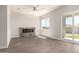 Spacious living room featuring tile floors, a modern fireplace, and a sliding glass door leading to the backyard at 14861 S Capistrano Rd, Arizona City, AZ 85123