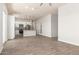 Open-concept living room featuring wood-look tile floors that connect to a modern kitchen with a center island at 14861 S Capistrano Rd, Arizona City, AZ 85123