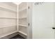 Well-organized pantry with ample shelving for storage and frosted glass door at 14861 S Capistrano Rd, Arizona City, AZ 85123
