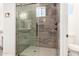 Modern walk-in shower with rainfall showerhead, glass door and tiled accent wall at 14861 S Capistrano Rd, Arizona City, AZ 85123