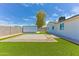 Spacious backyard with artificial grass, large storage shed, and paver patio area at 1510 W 7Th Dr, Mesa, AZ 85202