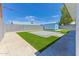 Artificial grass backyard with paver patio, storage shed, and cinder block fence at 1510 W 7Th Dr, Mesa, AZ 85202