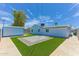 Well-kept backyard with artificial grass, a large storage shed, and a stone paver patio at 1510 W 7Th Dr, Mesa, AZ 85202