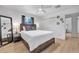 Comfortable bedroom features a ceiling fan, a large bed, and closet with mirror at 1510 W 7Th Dr, Mesa, AZ 85202