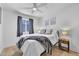 Cozy bedroom with wood floors and a ceiling fan, featuring neutral decor and plenty of natural light at 1510 W 7Th Dr, Mesa, AZ 85202