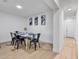 Modern dining room featuring a table, chairs, and contemporary artwork on the clean white walls at 1510 W 7Th Dr, Mesa, AZ 85202