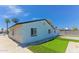 Home's exterior showing artificial grass with putting green, white paint, and block fencing at 1510 W 7Th Dr, Mesa, AZ 85202