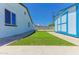 Side yard featuring artificial grass, putting green, storage shed, and white painted house at 1510 W 7Th Dr, Mesa, AZ 85202