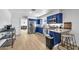 Bright kitchen features stainless steel appliances, blue cabinetry and island bar with stool seating at 1510 W 7Th Dr, Mesa, AZ 85202