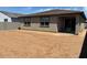 The backyard showcases a blank dirt canvas, awaiting your creative landscaping ideas at 16071 W Remuda Dr, Surprise, AZ 85387