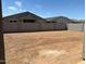 Spacious dirt backyard, enclosed by block walls, ready for landscaping and personalization at 16071 W Remuda Dr, Surprise, AZ 85387