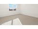 A bedroom with carpet, a window, and a neutral color scheme at 16071 W Remuda Dr, Surprise, AZ 85387
