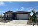 Charming single-story home featuring neutral paint, desert landscaping, and an attached two-car garage at 16071 W Remuda Dr, Surprise, AZ 85387