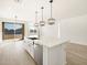 Bright kitchen features white cabinets, stainless steel appliances, pendant lighting and tile floors at 16071 W Remuda Dr, Surprise, AZ 85387