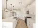 Bright, modern kitchen features white cabinets, quartz counters, stainless appliances, and stylish pendant lighting at 16071 W Remuda Dr, Surprise, AZ 85387