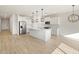 Modern white kitchen with stainless steel appliances and a large island at 16071 W Remuda Dr, Surprise, AZ 85387
