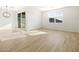 Open living space with tile floors, sliding glass door, and ample natural light at 16071 W Remuda Dr, Surprise, AZ 85387