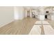 Spacious open-concept living area with tile flooring flowing into the modern kitchen at 16071 W Remuda Dr, Surprise, AZ 85387