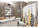 Bathroom featuring a vanity with a framed mirror, and a shower with a decorative curtain at 16384 W Salado Creek Dr, Surprise, AZ 85387