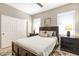 Relaxing bedroom features a wooden bed frame, ceiling fan, and bedside tables at 16384 W Salado Creek Dr, Surprise, AZ 85387