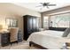 Comfortable bedroom featuring a workspace, decorative rug, and ample natural light at 16384 W Salado Creek Dr, Surprise, AZ 85387
