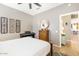 Comfortable bedroom with hardwood floors, ceiling fan, and decorative accents at 16384 W Salado Creek Dr, Surprise, AZ 85387