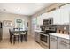Charming kitchen with dining area with modern appliances and stylish decor at 16384 W Salado Creek Dr, Surprise, AZ 85387