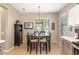Cozy dining area with a dark wood table, seating for six, and decorative chandelier at 16384 W Salado Creek Dr, Surprise, AZ 85387