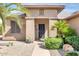 The front door of this home is inviting and features desert landscaping with a welcome sign at 16384 W Salado Creek Dr, Surprise, AZ 85387