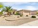 Inviting single-story home featuring desert landscaping and a two car garage with a covered front porch at 16384 W Salado Creek Dr, Surprise, AZ 85387