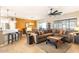 Open-concept living room featuring a large sectional sofa, ceiling fan, and natural light at 16384 W Salado Creek Dr, Surprise, AZ 85387