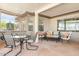 Covered patio featuring comfortable seating and a dining area, ideal for relaxing outdoors at 16384 W Salado Creek Dr, Surprise, AZ 85387