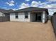 New home backyard featuring covered patio and block wall, ready for landscaping at 17043 W Fetlock Trl, Surprise, AZ 85387