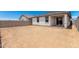 View of backyard featuring block wall surround, patio, and view of single-story home at 17043 W Fetlock Trl, Surprise, AZ 85387